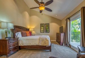 a bedroom with a bed and a ceiling fan at North Beach B in San Clemente