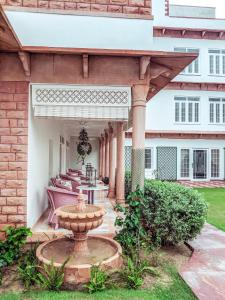 a patio with a fountain in front of a building at The Rohet House in Jodhpur