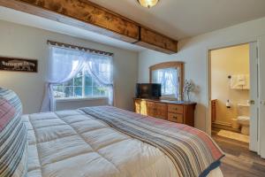 a bedroom with a bed and a bathroom with a toilet at Quiet in the Pines - Permit #3120 in Estes Park