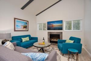 a living room with blue couches and a fireplace at Villa Del Mar in San Clemente