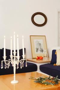 a living room with a table with a chandelier at Tamarix Del Mar Suites in Kamari