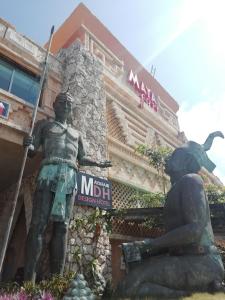 a statue in front of a hotel with a building at MayaFair Design Hotel in Canc&uacute;n