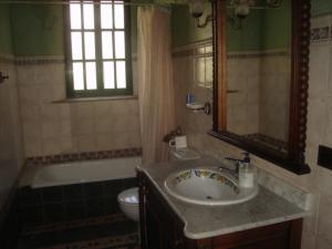 a bathroom with a sink and a tub and a toilet at El Cañuelo in Zahara de la Sierra