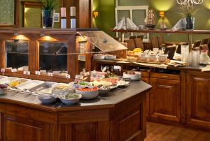 a buffet with bowls of food on a table at Tryp by Wyndham Luebeck Aquamarin in Lübeck