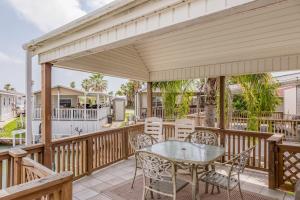 a patio with a table and chairs on a deck at Long Island Village Unit 278 in Port Isabel