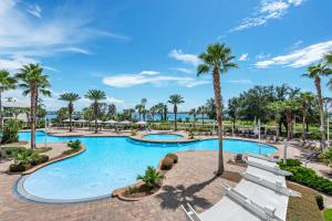 a pool at the resort with palm trees at Reflections At Bay Point II in Panama City Beach