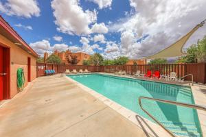 a swimming pool with chairs and a fence at Solano Vallejo 3283 in Moab