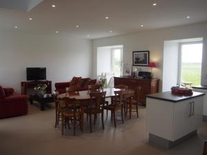 a living room with a table and chairs and a couch at Maison Leonard in Vains