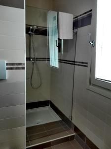 a shower with a glass door in a bathroom at B&B Day by day in Iseo