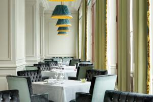 a dining room with tables and chairs and a chandelier at Savoia Excelsior Palace Trieste - Starhotels Collezione in Trieste +31 photos