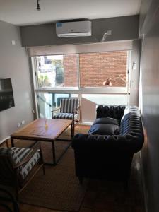 a living room with two couches and a table at Castex Palermo Chico in Buenos Aires