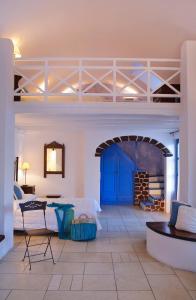 a large room with a bed and a table at Tamarix Del Mar Suites in Kamari