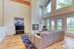 a living room with a couch and a tv at Cascade Mountains View in Sunny Shore Acres