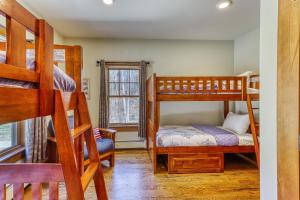 a bedroom with two bunk beds and a bed at Lake Rescue Retreat in Ludlow