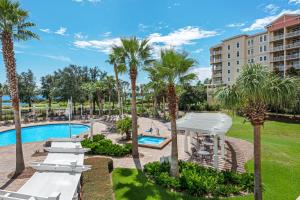 a resort with a pool and palm trees at Reflections At Bay Point II in Panama City Beach