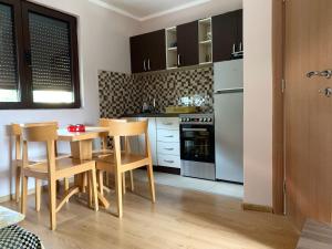 a kitchen with a table and chairs in a room at City Centre in Žabljak