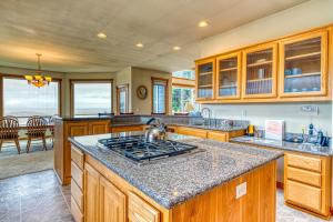 a kitchen with a stove top oven in a room at Agate Beach Haven - 4 Bed 4 Bath Vacation home in Bandon in Bandon