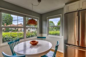 a kitchen with a table and chairs and a refrigerator at Alki Beach House in Seattle