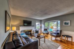 a living room with a couch and a fireplace at Alki Beach House in Seattle