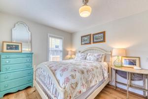 a bedroom with a bed and a blue dresser at Halcyon House in Rockaway Beach