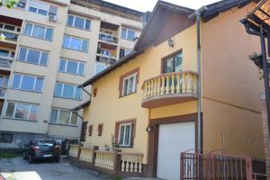 a apartment building with a balcony and a garage at Sofija in Višegrad