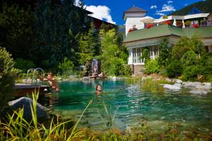 grupa ludzi pływających w basenie w obiekcie Salzburgerhof, das 5-Sterne Hotel von Zell am See w mieście Zell am See