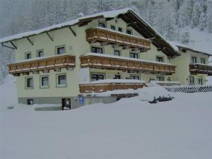a large building with snow in front of it at Haus Gstrein in Obergurgl