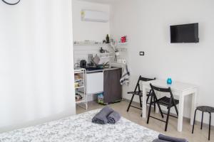 a room with a bed and a desk and chairs at Donna Nunzia Home in Noto