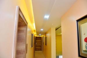 a hallway in a hospital with yellow ceilings at Lit Suites in Abuja