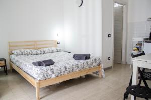 a bedroom with a bed with two pillows on it at Donna Nunzia Home in Noto