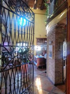 a wrought iron gate in a room with a brick wall at La Toscana in Murcia