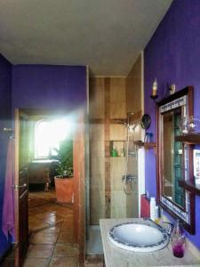 a bathroom with a tub and a purple wall at La Toscana in Murcia