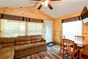 a living room with a couch and a table at O'Connell's RV Campground Deluxe Park Model 38 in Inlet