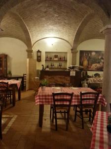a restaurant with tables and chairs in a room at Agriturismo La Fattoria Del Boschetto in Fontanellato