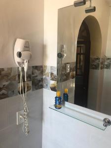 a bathroom with a hair dryer and a mirror at Hostel Revolution Quito in Quito