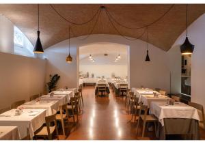 a dining room with white tables and chairs at Phi Hotel Canalgrande in Modena
