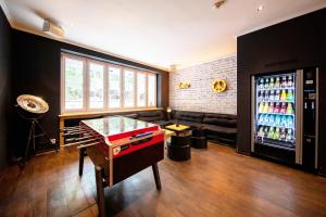a room with a large soda machine and a table at Sonata City Hotel in Cologne