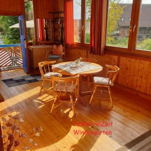 a dining room with a table and chairs at FeWoFreiZeit in Rheinau