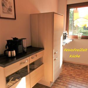 a kitchen with a counter with a microwave in it at FeWoFreiZeit in Rheinau +14 photos
