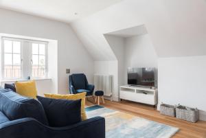 a living room with a blue couch and a tv at Luxurious living in Gullane in Edinburgh