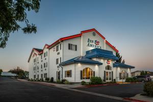 a large white building with a sign on it at Inn America - Boise in Boise