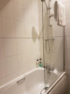 a bathroom with a shower and a bath tub at ZenStay in Sunderland