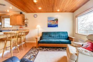 a living room with a blue couch and a kitchen at Sitka Sky in Oceanside