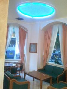 a living room with a blue light on the ceiling at Diethnes in Larisa