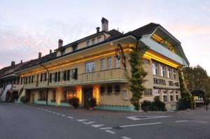 un hotel con luces en el lateral de un edificio en Hôtel Restaurant Cave Bel-Air en Praz