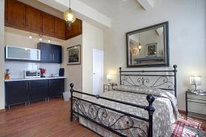 een slaapkamer met een zwart bed en een keuken bij Nerii 2 in Florence