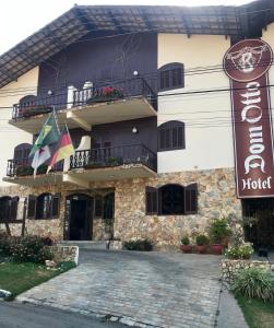 a hotel with a sign in front of it at Hotel Dom Otto in Vespasiano