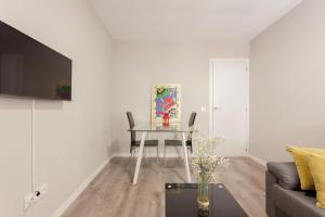 a living room with a table and a couch at APARTAMENTOS EL PARAÍSO in Logroño