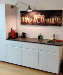 a kitchen with a white counter and a sink at Appt Berlin in Berlin