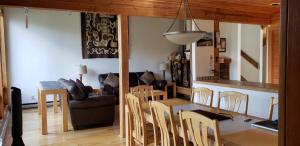 a kitchen and living room with a table and chairs at Invermere Luxury 4 Bedroom Mountain Lake View Home - Sleeps 8, 2 decks, Huge Yard, Walk to Town -Beach, Tennis, Golf at 12 Courses - Hot Springs Close By!! in Invermere